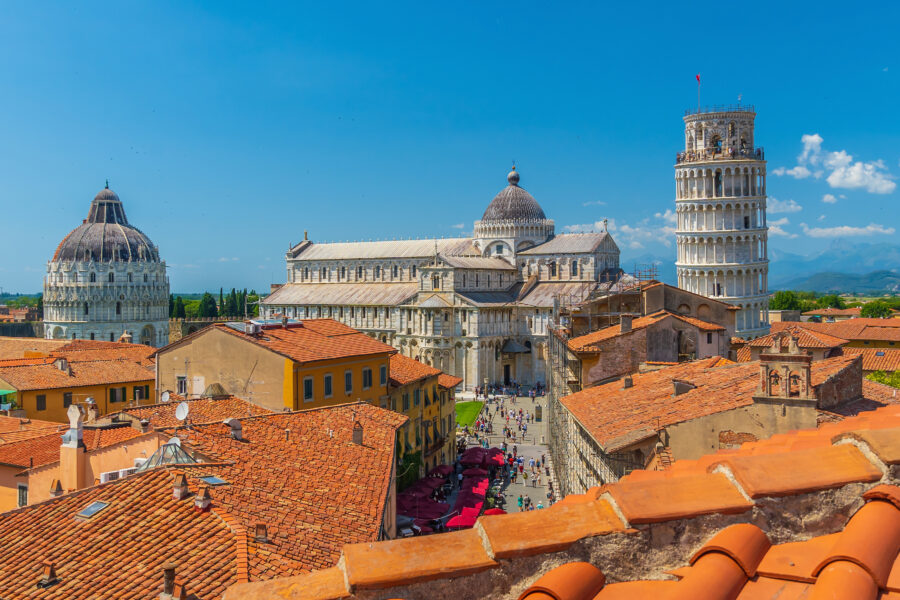 The Leaning Tower of Pisa stands prominently in a charming neighborhood of Pisa, Italy, showcasing its iconic tilt