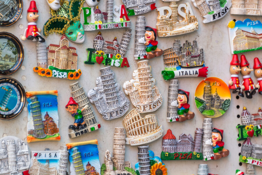 Colorful souvenir magnets depicting the Leaning Tower of Pisa, highlighting its famous lean and historical significance