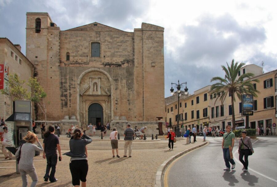 Striking architecture with a large clock tower, prominently displayed at Placa del Princep in Mahon, Menorca.