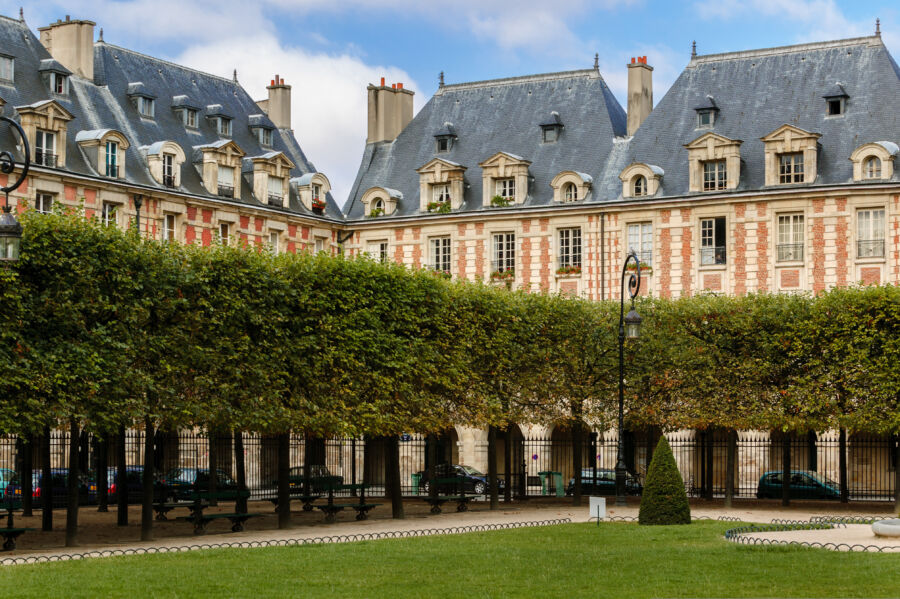 Place des Vosges in Le Marais, Paris, showcasing its stunning architecture and serene atmosphere amidst vibrant surroundings