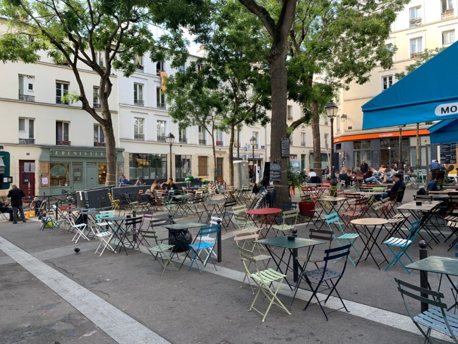 Restaurant outdoor seats at Place Sainte-Marthe in Paris, France