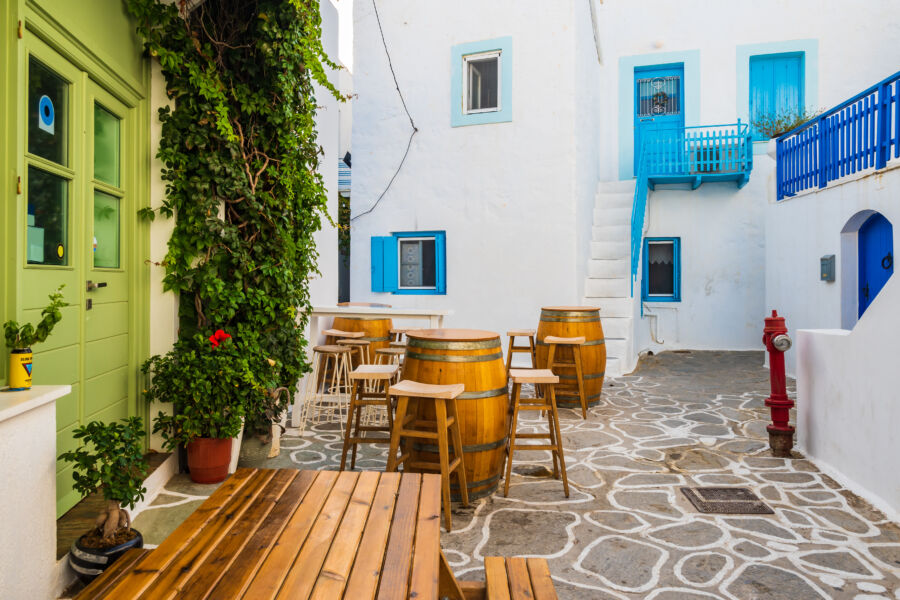 Narrow streets of Plaka village lined with traditional white houses showcasing classic Greek architecture, Milos, Cyclades.