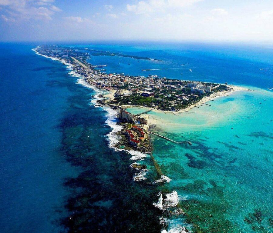 Scenic view of Playa Norte, Isla Mujeres, showcasing white sand beach and turquoise waters under a clear blue sky.
