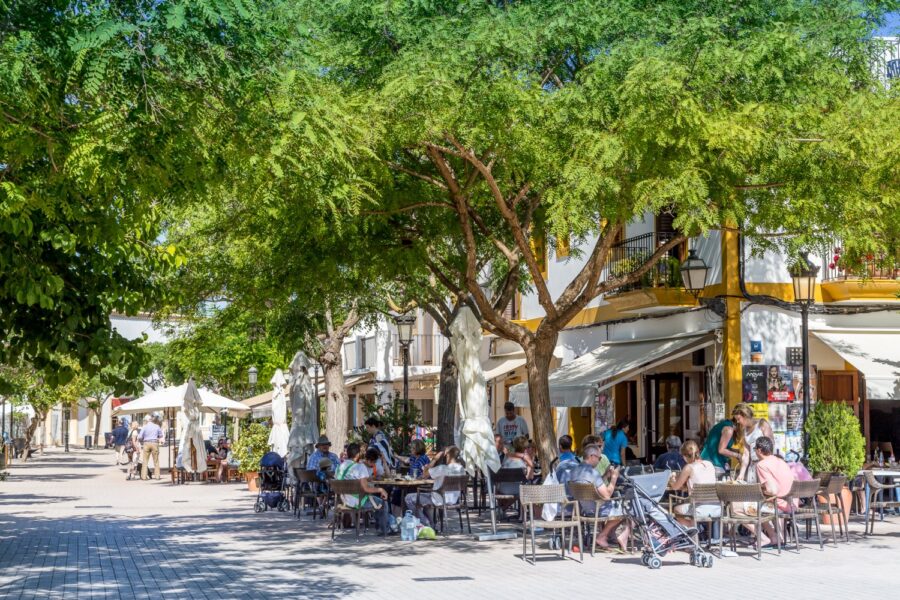 Outdoor dining at a charming, tree-lined plaza in Santa Gertrudis, Ibiza.
