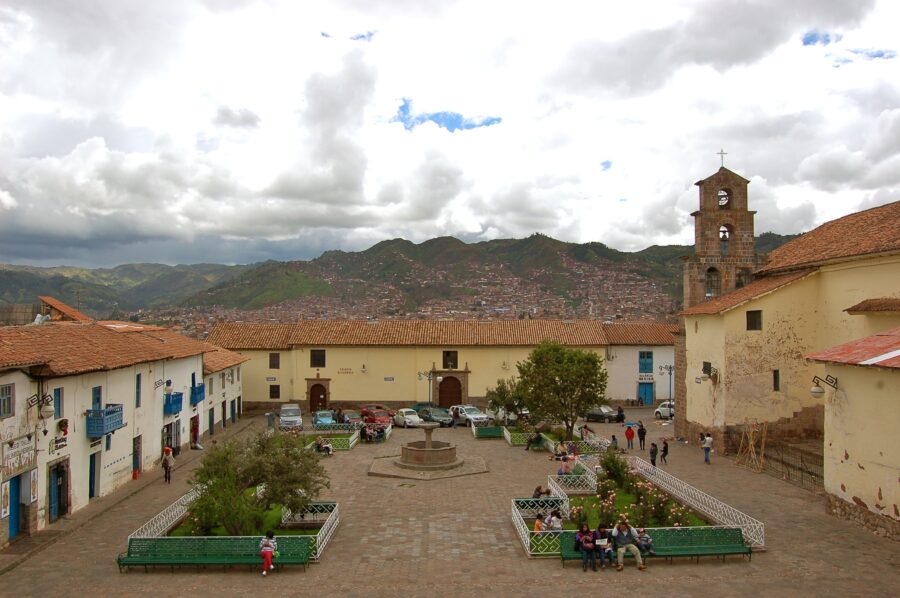 Plaza San Blas in Cusco, Peru features a prominent large building with a clock tower, highlighting its cultural significance.