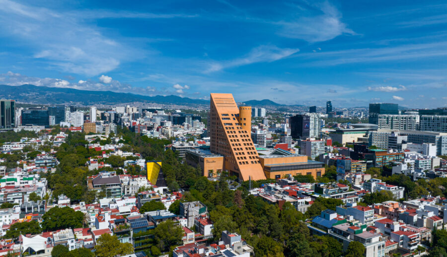 Expansive view of a sunrise in Polanco, Mexico City, featuring the skyline illuminated by soft, morning light