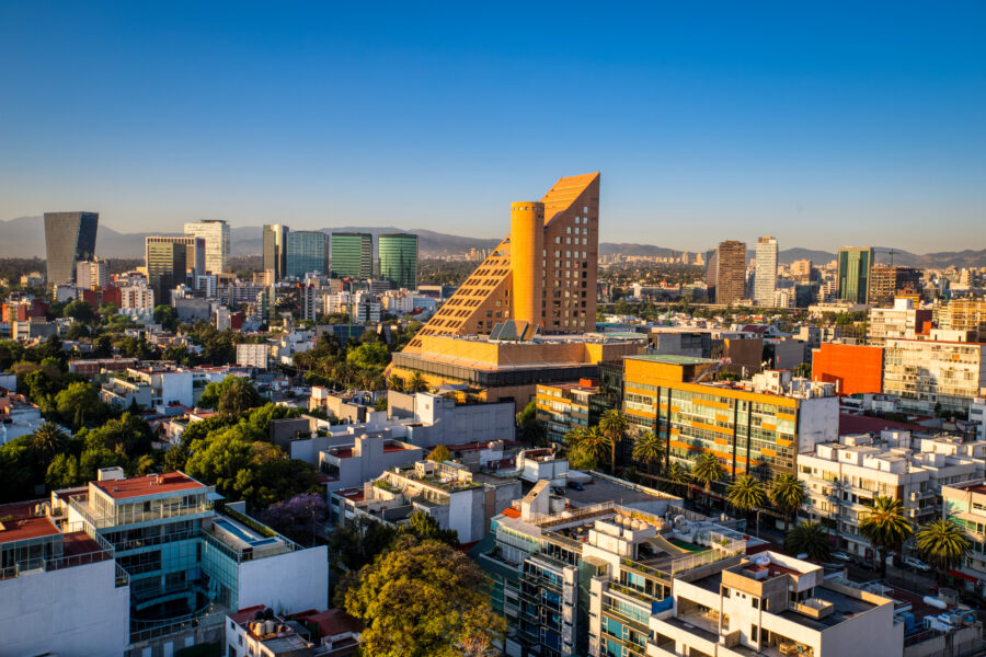 Panoramic view of a vibrant sunrise over Polanco, Mexico City, showcasing the skyline and colorful clouds