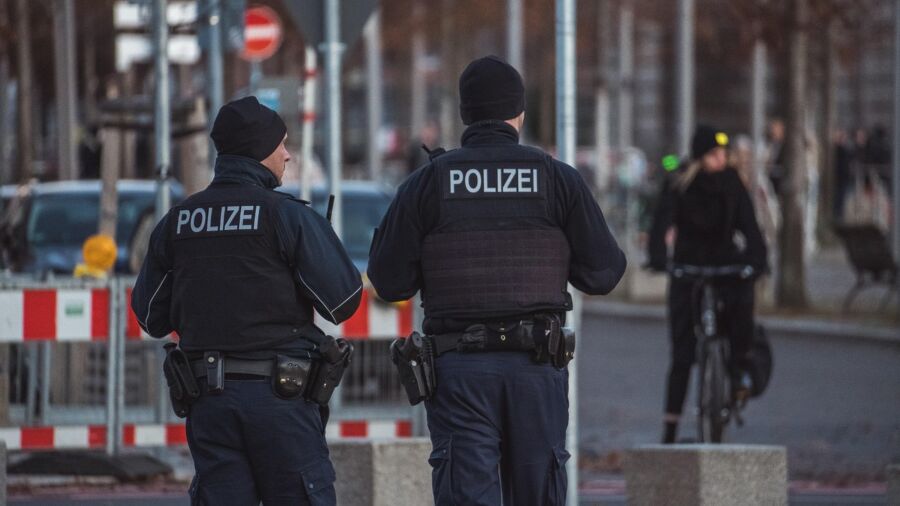 Police officers in urban setting ensuring safety amid cyclists and city traffic.