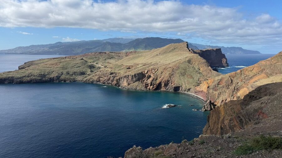 Scenic vista from Ponta de São Lourenço, featuring a mountain summit with the ocean stretching into the horizon.
