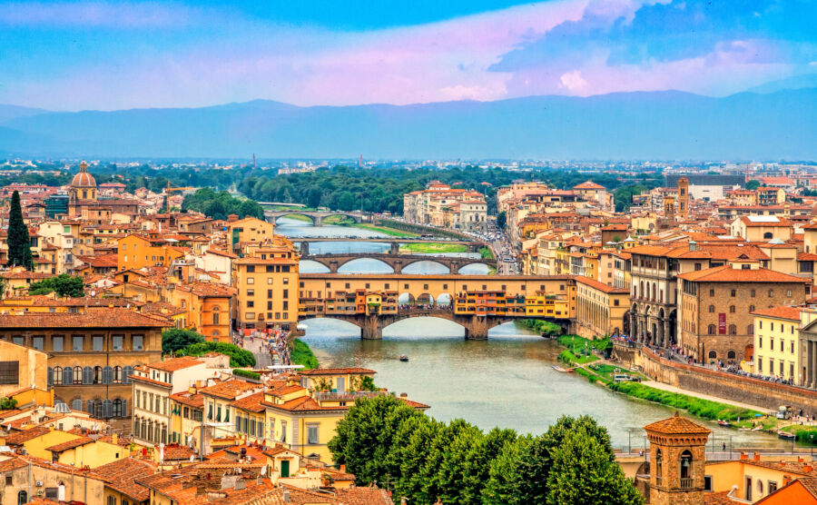 Scenic panorama of the Ponte Vecchio, a medieval stone bridge over the Arno River in Florence, highlighting its iconic structure