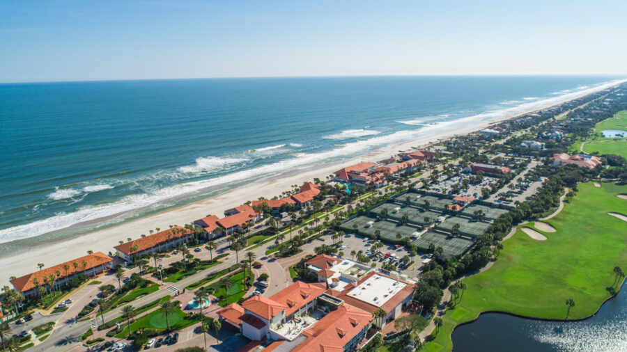 Scenic view of Ponte Vedra Beach in Jacksonville, Florida, featuring sandy shores and gentle ocean waves under a clear sky.