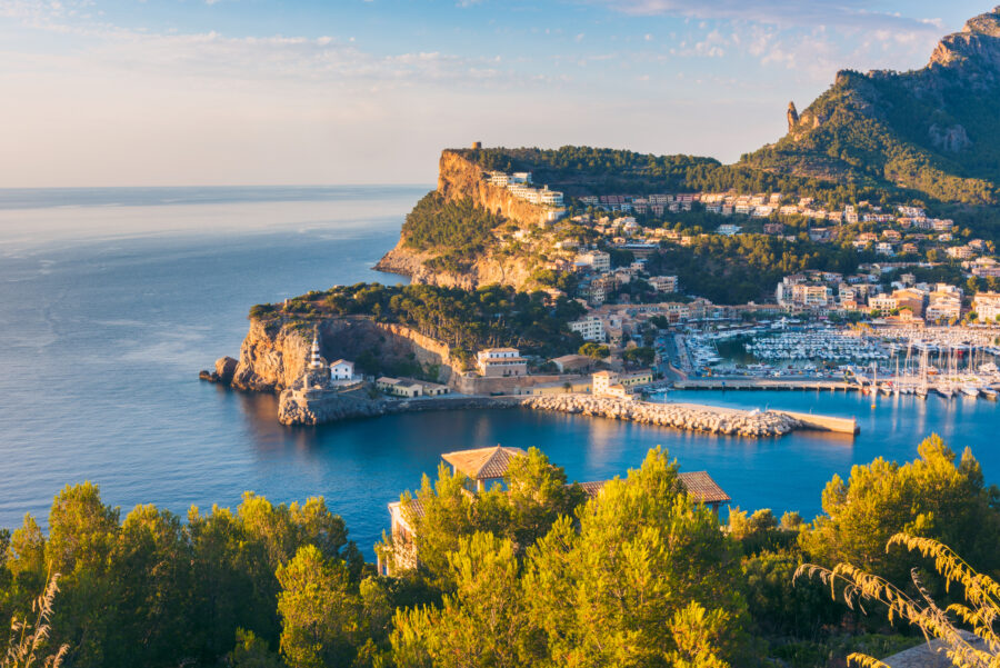 Picturesque sunset at Port de Soller, Mallorca, showcasing colorful skies and calm waters with boats anchored