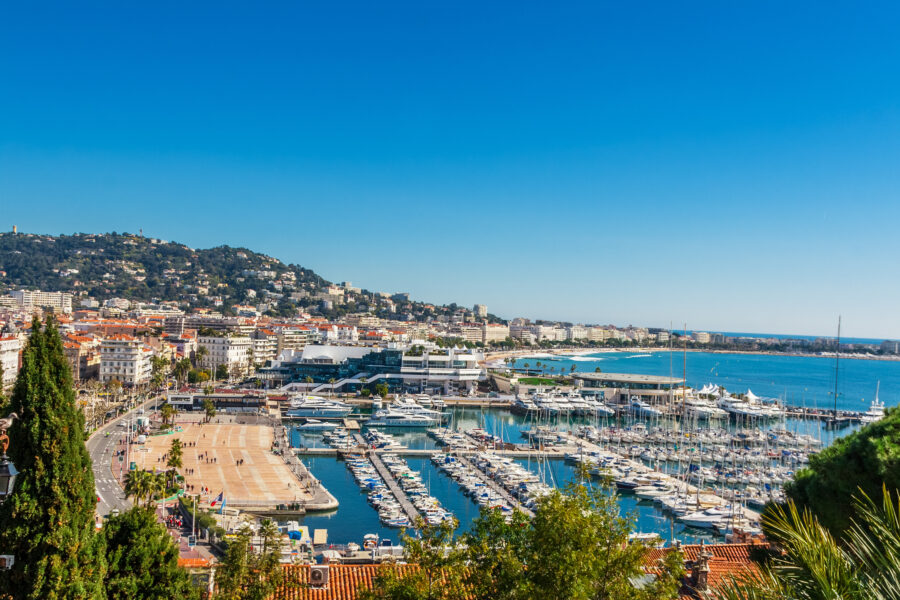 Scenic panorama of Cannes' Promenade de la Croisette and Port Le Vieux, highlighting the stunning Cote d'Azur coastline