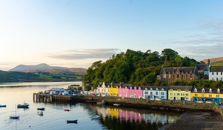 Colorful houses line the waterfront in Portree, Isle of Skye, creating a picturesque town scene.