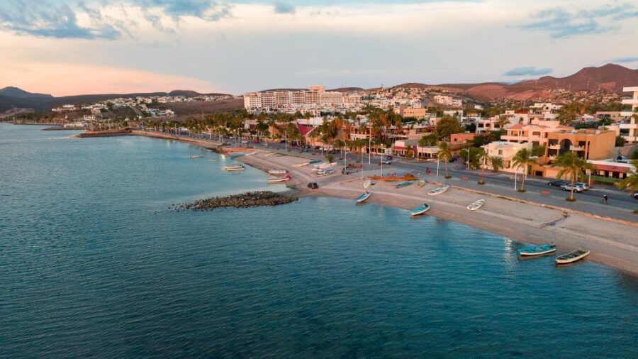 Scenic view of the beach and town, showcasing Posada de las Flores La Paz in the foreground.