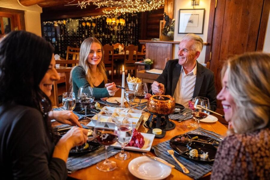 Diners gathered around a table, sharing food and conversation at Post Hotel & Spa.
