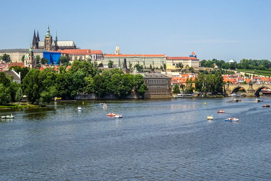 Prague Castle and Vltava River view with historic architecture and vibrant landscape.
