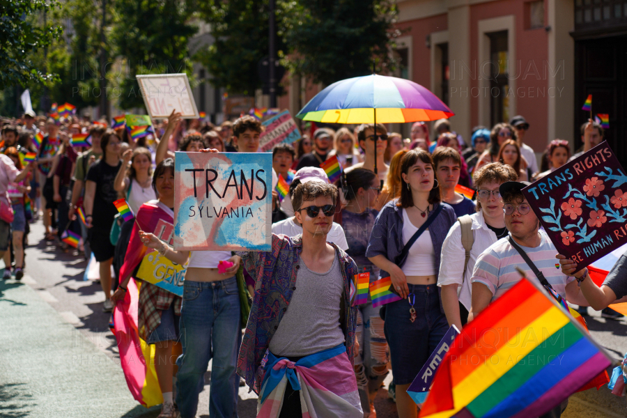 Transgender pride parade in Cluj-Napoca, vibrant diversity, flags, and celebration of rights.