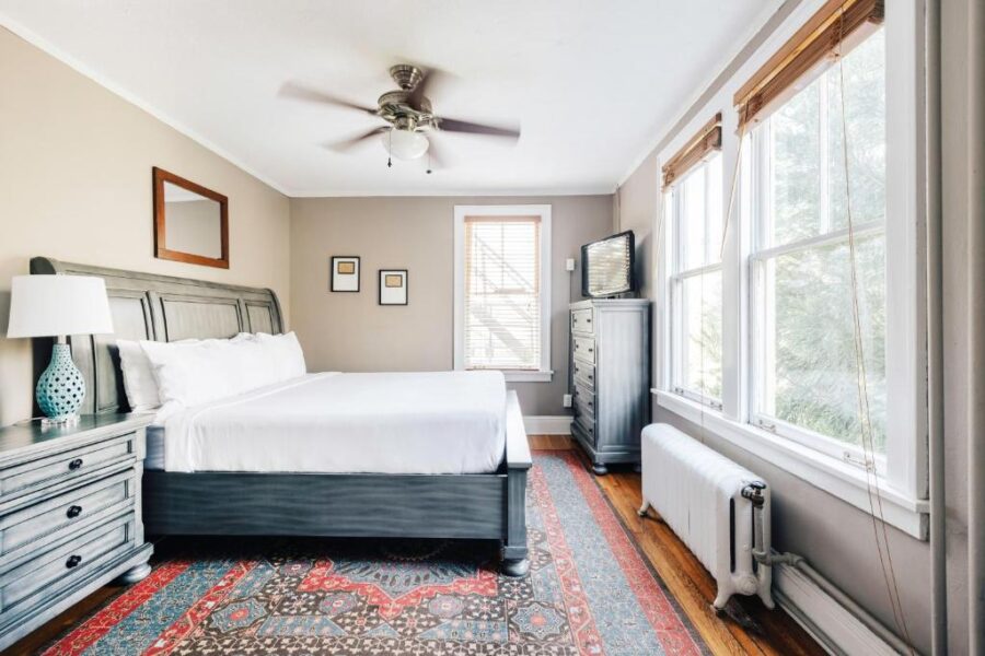 Cozy bedroom featuring a large bed and a window, showcasing the inviting atmosphere of Princess Anne Boutique Hotel.