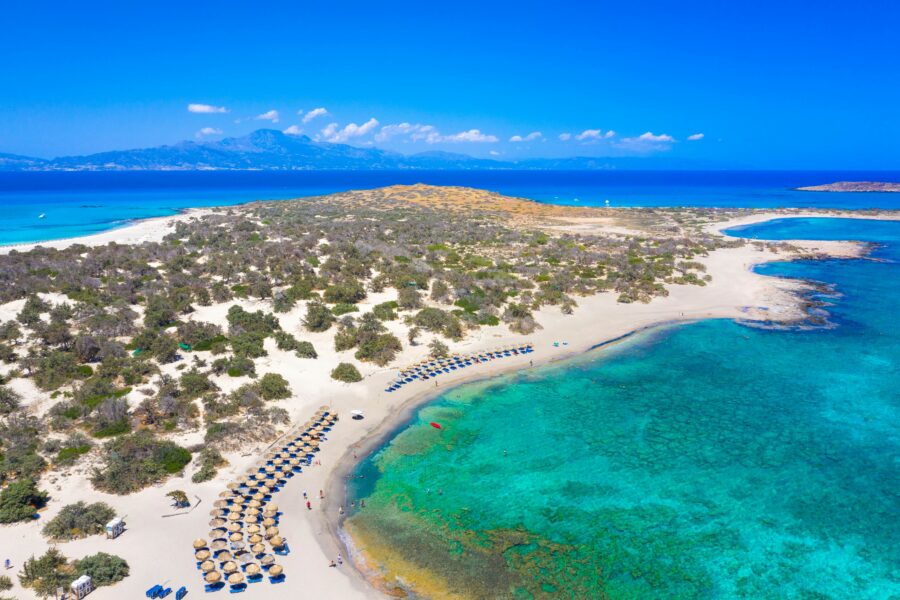 Turquoise waters, golden sands, scenic island; a serene and picturesque beach paradise.