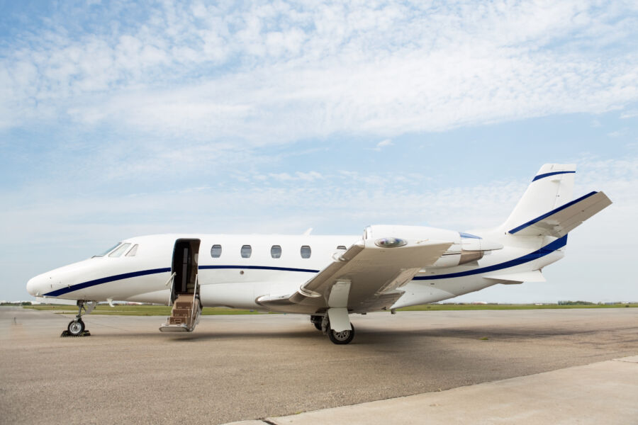 Close-up view of a private jet parked at the terminal, showcasing its sleek design and luxurious features