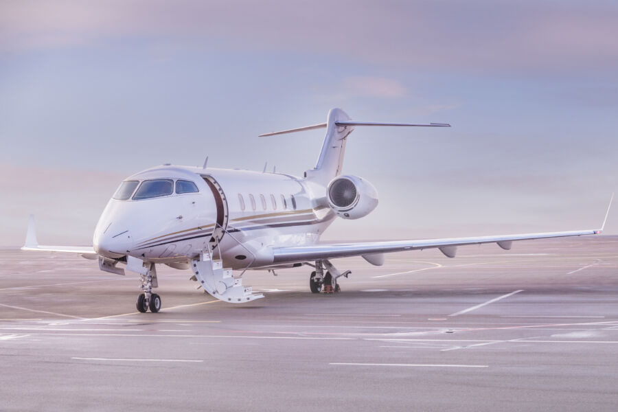 Private jet parked at the airport and a sunset view