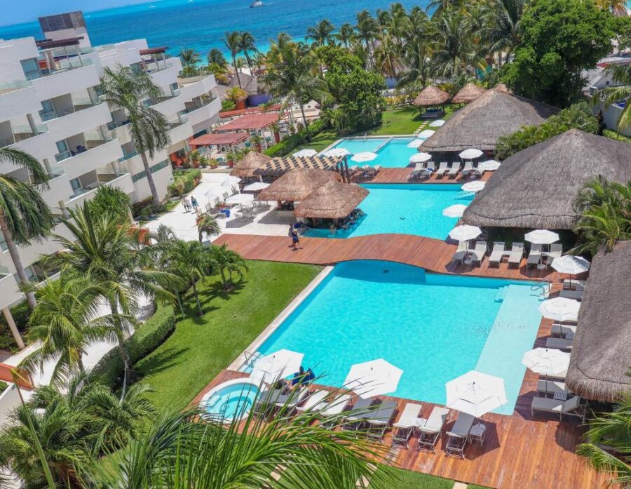 Aerial view of Privilege Aluxes Adults Only resort featuring a pool surrounded by lounge chairs on Isla Mujeres.
