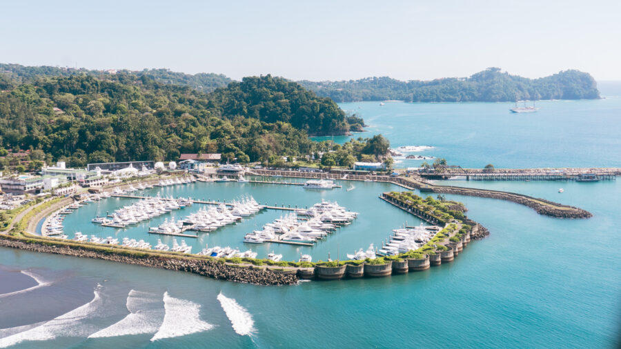 Aerial of the Marina Pez Vela in Manuel Antonio, with boats and the National Park in the background, Quepos, Puntarenas, Costa Rica