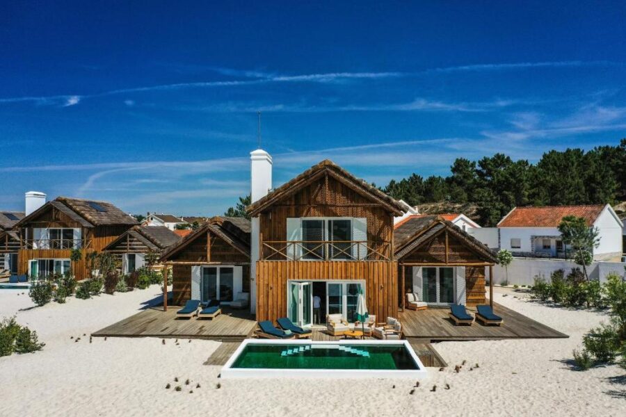 Quinta Da Comporta beach house featuring a pool and wooden deck, set in a serene coastal environment.