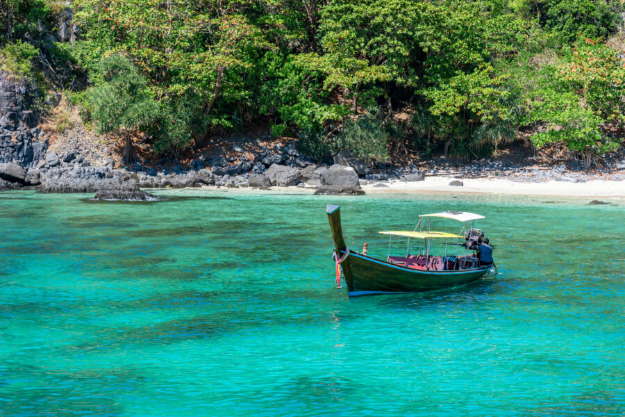 Boat in the turquoise sea near Racha Island, part of the Phi Phi Islands in Thailand