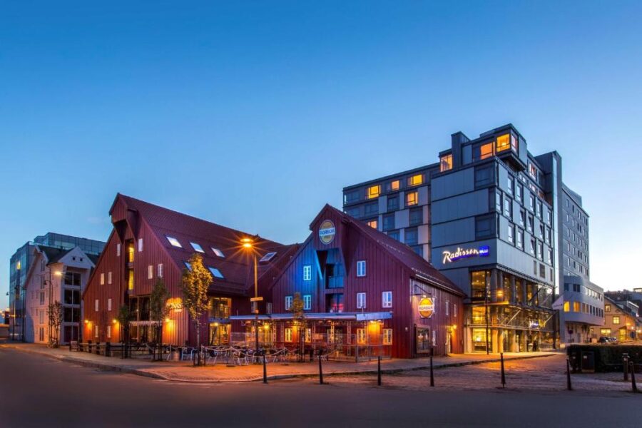 Exterior view of the Radisson Blu Hotel Tromsø, showcasing its modern architecture against a clear sky.
