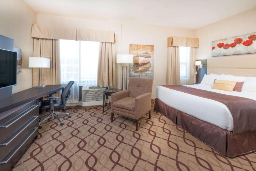 Hotel room at Ramada by Wyndham St. John's featuring a bed, desk, and television in St. John, Canada.