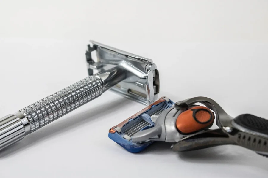 Comparison of classic safety razor and modern disposable razor on white background.