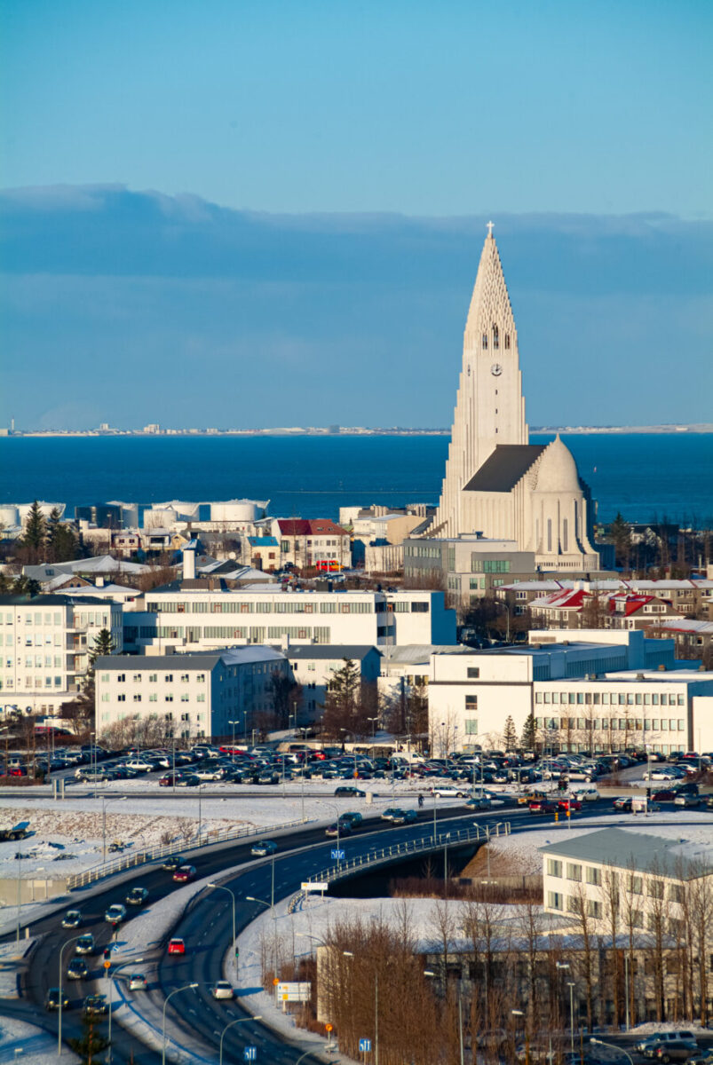 Reykjavik, Iceland's capital, blanketed in snow, showcasing colorful buildings against a wintery landscape.