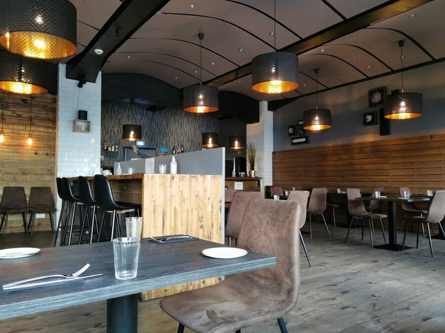 Interior of Reykjavik Kitchen in Iceland, showcasing wooden walls and tables in a warm, inviting atmosphere.