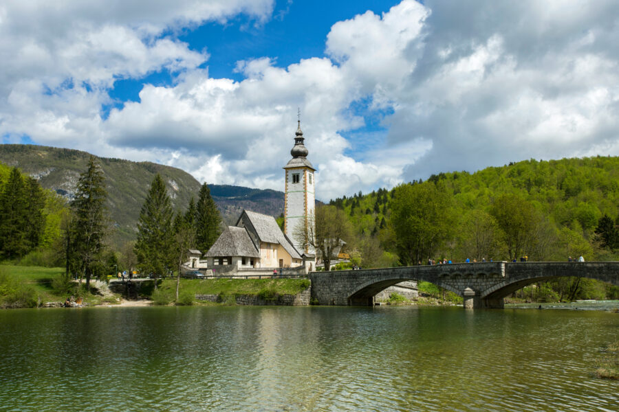 Scenic view of Ribcev Laz village by Bohinj Lake in Slovenia, showcasing lush landscapes and tranquil waters