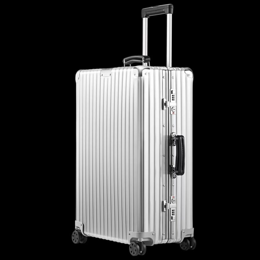 Silver Rimowa Check-In M Aluminum suitcase with wheels on a black background.
