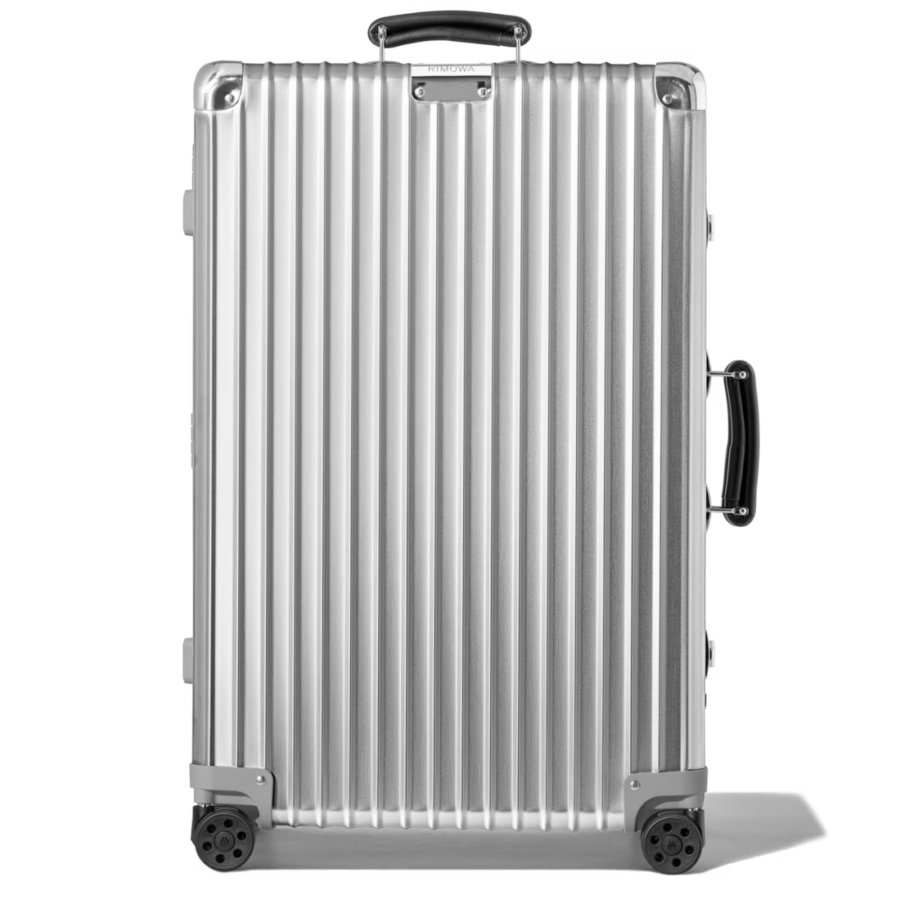 Silver aluminum Rimowa Check-In M suitcase with wheels displayed on a solid black background.