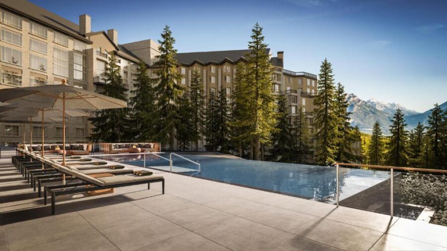 The elegant pool area at the Ritz-Carlton Banff, with breathtaking mountain scenery, part of Rimrock Banff, Emblems Collection.