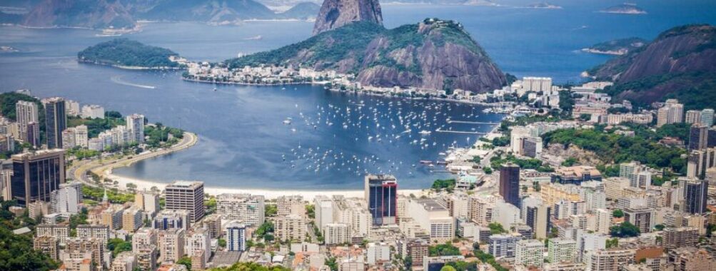 Aerial view of Rio de Janeiro cityscape, Sugarloaf Mountain, and scenic bay.