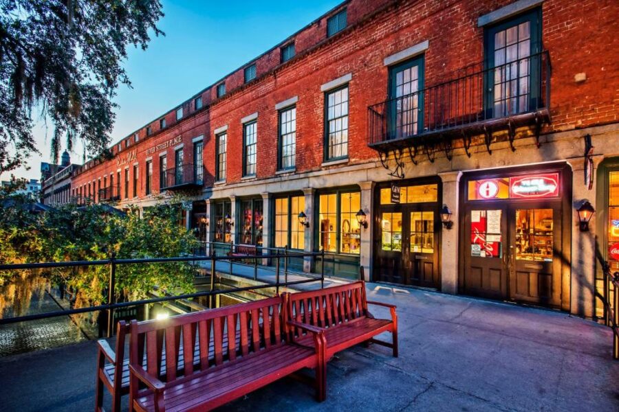 Exterior view of River Street Inn, featuring a red brick facade and a bench positioned outside for visitors.
