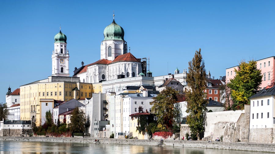 St. Stephens Cathedral in Passau with green domes on the Danube waterfront.