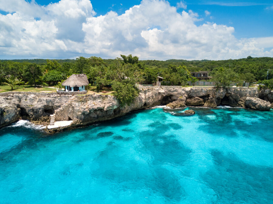 Rockhouse Hotel perched on a cliff in Negril, Jamaica, showcasing stunning ocean views and lush tropical surroundings