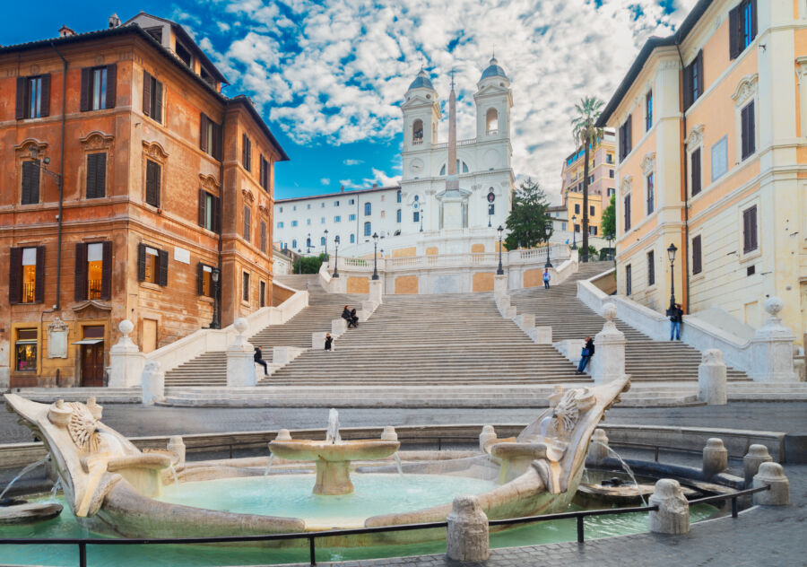 The iconic Spanish Steps in Rome, Italy, featuring a beautiful fountain at their base, surrounded by historic architecture