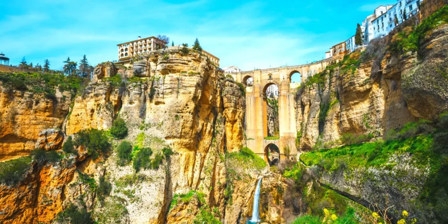 Rondas El Tajo Gorge with historic stone bridge and Andalusian village.