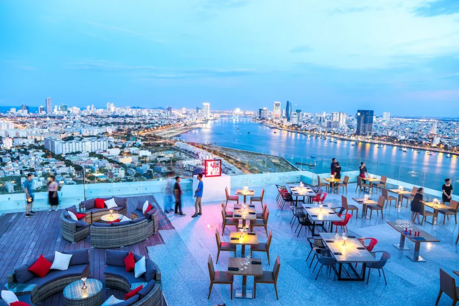 Rooftop bar with river and city skyline view at dusk in Da Nang, Vietnam.
