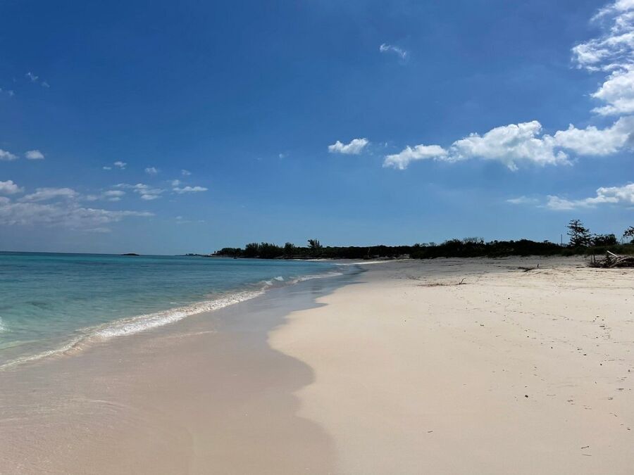 Beachfront property listing photo at Rose Island, featuring pristine sand and turquoise waters at the end of the road, Bahamas.