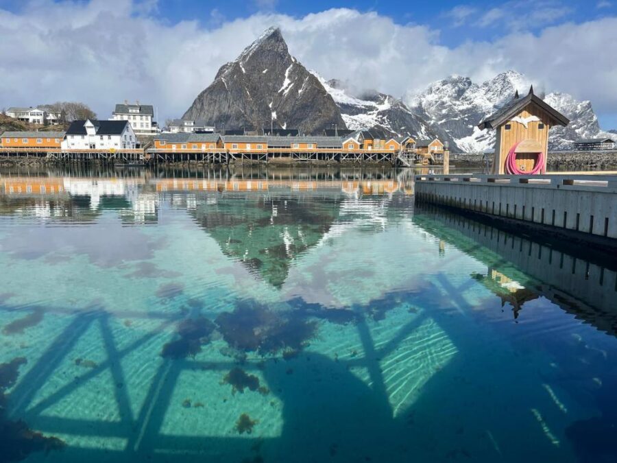 Scenic view of the Lofoten Islands in Norway, featuring the rustic Rostad Retro Rorbuer cabins by the water.