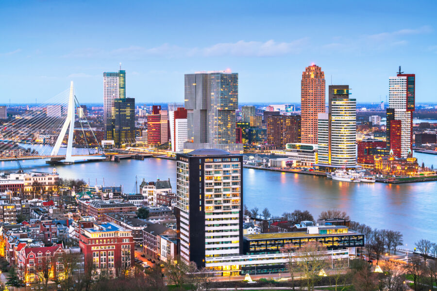 The skyline of Rotterdam, Netherlands, featuring contemporary buildings and a dynamic urban landscape against the sky