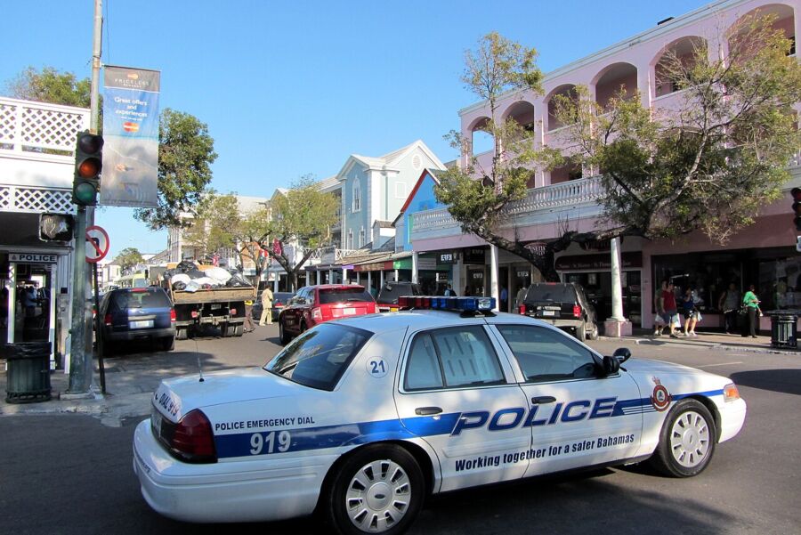 Royal Bahamas Police Ford Crown Victoria No. 21 parked on the roadside, with its lights flashing.
